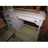 A kneehole dressing table, fitted with an arrangement of four drawers raised on turned and bracket