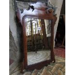 A small Chippendale revival wall mirror with carved fretwork outline and moulded detail