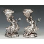 Exquisite pair of Victorian silver figural table salts in the form of sea maidens upon the back of