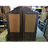 A Victorian two fold screen with shaped outline and carved dragon and scrolling acanthus detail