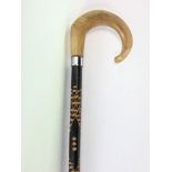 Hiking stick with goat horn handle and carved shaft