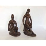 A pair of cast resin bronzed nude female characters, signed S Mitchell, the largest 30 cm high