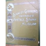 A Stanley Gibbons stamp album containing a quantity of British and worldwide stamps together with