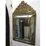 A 19th century cushion moulded wall mirror with bevelled edge plate surround with applied embossed