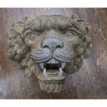 A carved wooden architectural lions mask with well detailed features.