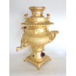 Gilt metal baluster electric samovar, decorated in relief with arch panels and figures, 40cm high