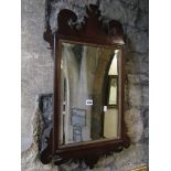 A Chippendale revival wall mirror of rectangular form with bevelled edge plate, gilt moulded slip,