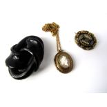 An enamel brooch in scrolling mount, a cameo necklace and a further brooch of knot design