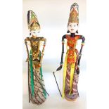 A pair of far eastern (possibly Indonesian) theatrical puppets of a gentleman and his partner in