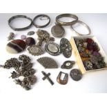 An interesting collection of mostly silver items including two charm bracelets, four hinged bangles,