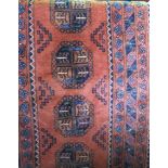 Persian runner with central blue and red medallions upon an orange ground, 280 x 90cm