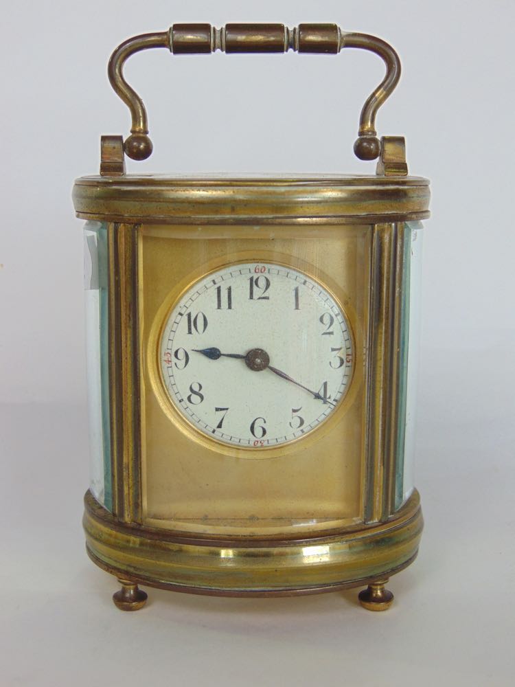 Good 19th century oval brass carriage clock fitted with a circualr enamelled dial on a gilt plate,