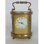 Good 19th century oval brass carriage clock fitted with a circualr enamelled dial on a gilt plate,