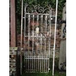 A pair of 19th century wrought iron pedestrian gates with scrollwork detail and painted finish