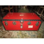 A traditional travelling trunk in a red and black colourway