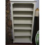 A contemporary pine freestanding open bookcase with moulded outline and five adjustable shelves with