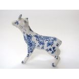 A small 19th century Delft model of a goat-like animal with blue and white painted floral decoration