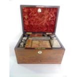 A 19th century rosewood and pearl inlaid dressing chest, the hinged lid enclosing many white metal