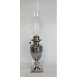 Good quality silver plated baluster oil lamp with embossed ribbon band, 26cm high