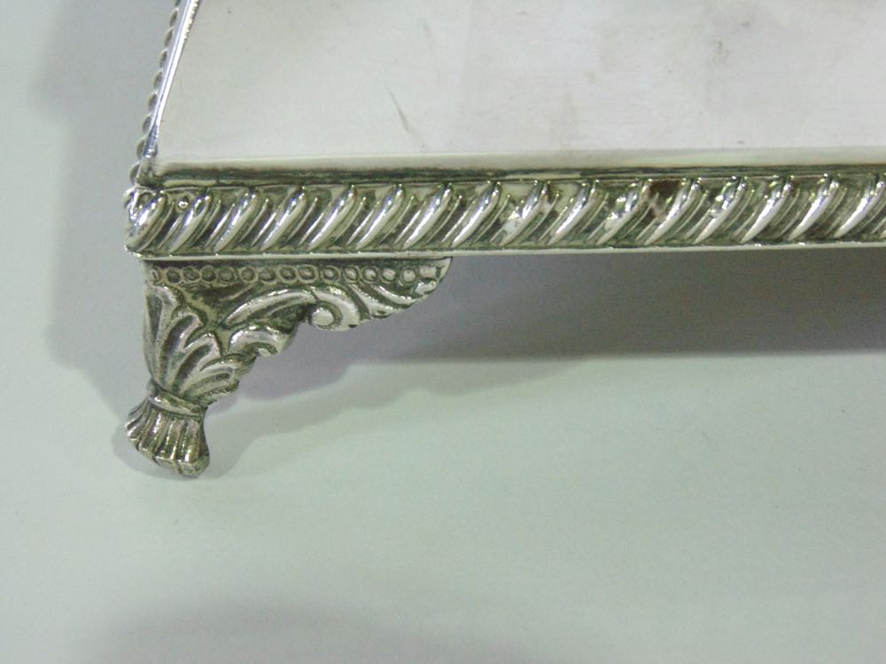 Silver plated square plinth type stand with gadrooned rim and cast scrolled feet, 13cm x 38cm wide - Image 2 of 2