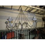 A contemporary painted steel hanging ceiling light with six simple scrolling branches with ball/