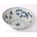 A Chinese bowl with polychrome painted dragon and flaming pearl detail and six character mark to