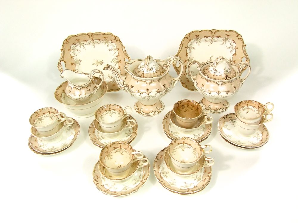 A collection of mid 19th century tea wares with gilded fruiting vine detail comprising tea pot,