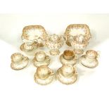 A collection of mid 19th century tea wares with gilded fruiting vine detail comprising tea pot,