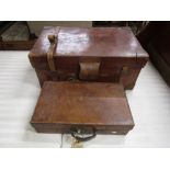 A good quality (heavy gauge) tan leather suitcase with reinforced corners and brass fittings,