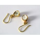 A pair of closed set diamond drop earrings in yellow metal