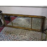 A 19th century gilt framed overmantle mirror the triple plate with moulded column surround with