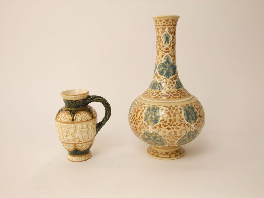 An early 20th century Hungarian Zsolnay Pecs bottle shaped vase with moulded and painted scrolling