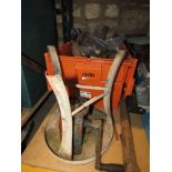 A collection of vintage agricultural effects including a butter churn, horse bits, bull leading