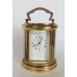 Miniature oval brass carriage clock the enamelled dial inscribed "L'Epee", 8cm high