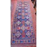 Persian floor runner with geometric medallions upon a blue ground; together with a further thick