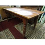 A Victorian style pine farmhouse kitchen table of rectangular form raised on four turned, tapered
