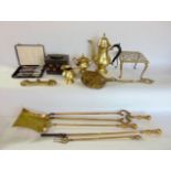 A mixed collection of metalware to include mainly brass fire tools and trivets