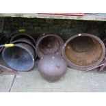 Seven vintage reclaimed cast iron tubs of circular tapered form with pronounced rims, together