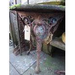 A Victorian cast iron pub table of circular form with decorative pierced detail and swept tripod