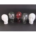 Three glass heads to include one in red glass together with two ceramic examples (5)