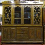 A substantial and good quality Eastern hardwood four door enclosed cabinet, the lower section fitted