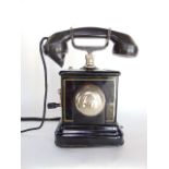 A vintage japanned metal Danish telephone receiver with side winding handle.