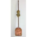 An interesting Tibetian copper shovel with brass relief decoration.