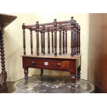 A Regency rosewood four divisional canterbury with turned spindle mouldings over a frieze drawer