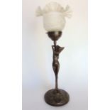 A bronze figural table lamp of a nude with an opaque glass shade, indistinctly signed to base, 41 cm