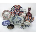 A collection of oriental ceramics including an Imari bowl with shaped rim, a bottle shaped vase with