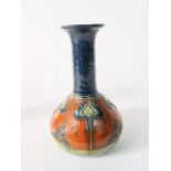 An early 20th century art pottery vase with globular body and drawn neck, with incised and painted