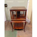 An Edwardian mahogany revolving bookcase on stand raised on four cabriole supports and under