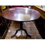 A Georgian mahogany snap top occasional table on a turned vase shaped pillar and tripod base