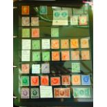 A folder containing a collection of mint GB stamps from QV to QE including a very large quantity